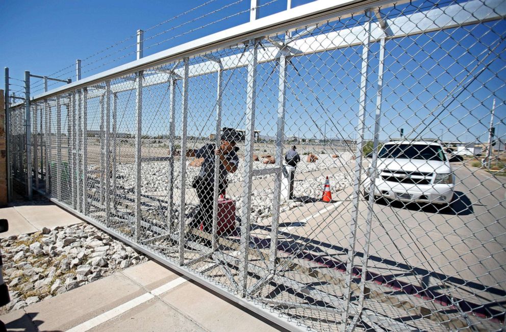 PHOTO: An agent with the Department of Homeland Security closes the exterior gate of the holding facility for immigrant children in Tornillo, Texas, near the Mexican border, June 12, 2018.