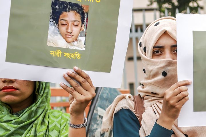 Bangladeshi women hold placards and photographs of schoolgirl Nusrat Jahan Rafi at a protest in Dhaka following her murder by