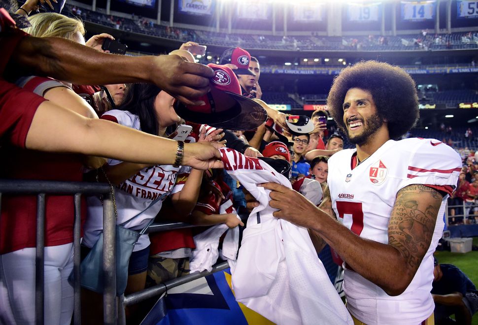 San Francisco 49ers quarterback Colin Kaepernick signs autographs for fans after a 31-21 win over the San Diego Chargers on S