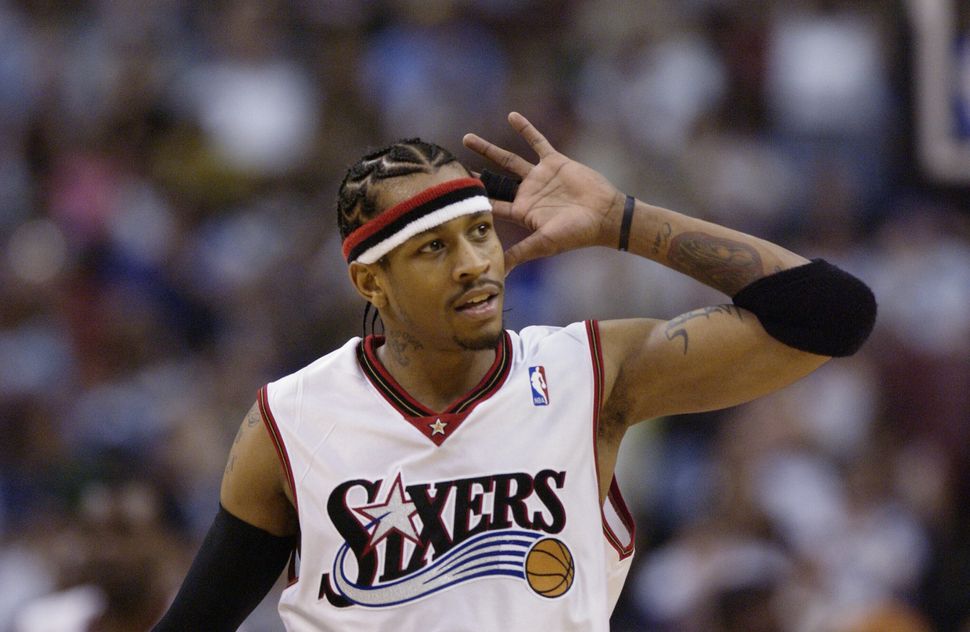 Allen Iverson of the Philadelphia 76ers gestures to hear cheers from the crowd during a game against the Washington Wizards o