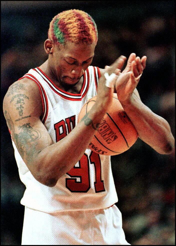 Chicago Bulls forward Dennis Rodman claps after making a free throw that sealed a victory against the Los Angeles Lakers in t
