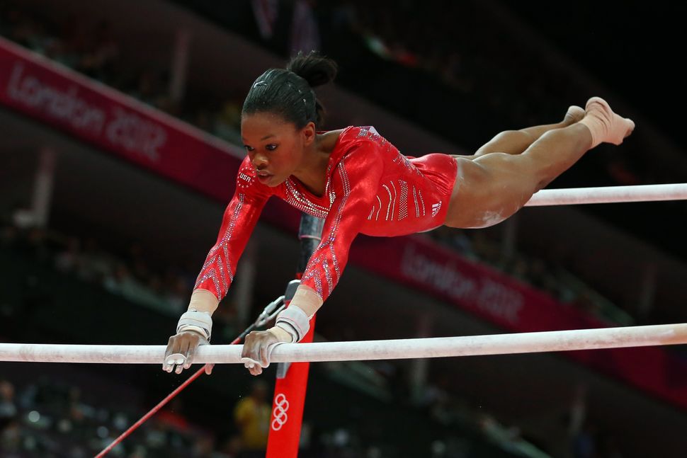Gabby Douglas competes on the uneven bars in the artistic gymnastics women's team final at the London Olympics on July 31, 20