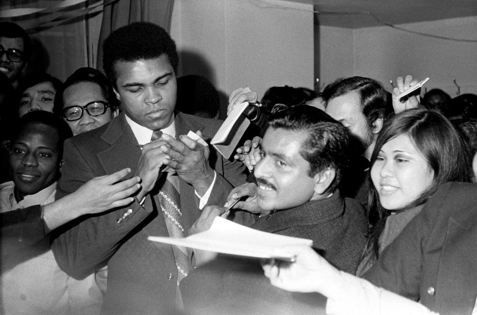 The future Muhammad Ali signs autographs for adoring fans two days before his Feb. 10, 1962, bout with Sonny Banks in New Yor