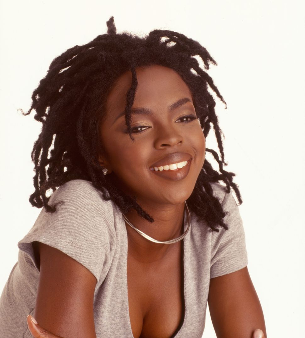 Portrait of American pop and rhythm &amp; blues musician Lauryn Hill as she poses against a white background, 1998.