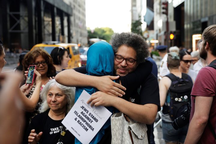 Activist Linda Sarsour hugs a friend as she prepares for the beginning of a demonstration and Iftar celebration during Ramada