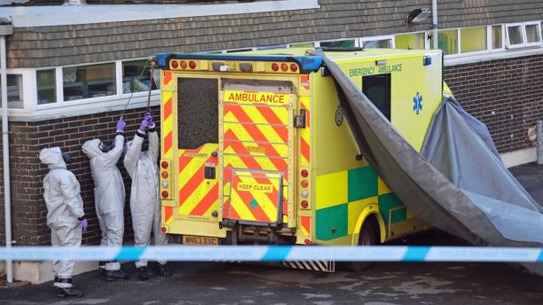 Military personnel in gas masks prepare to remove a second ambulance from the South Western Ambulance Service station in Harnham, near Salisbury, England, Saturday March 10, 2018, as police and members of the armed forces probe the suspected nerve agent attack on Russian double agent Sergei Skripal which took place Sunday. (Andrew Matthews/PA via AP)