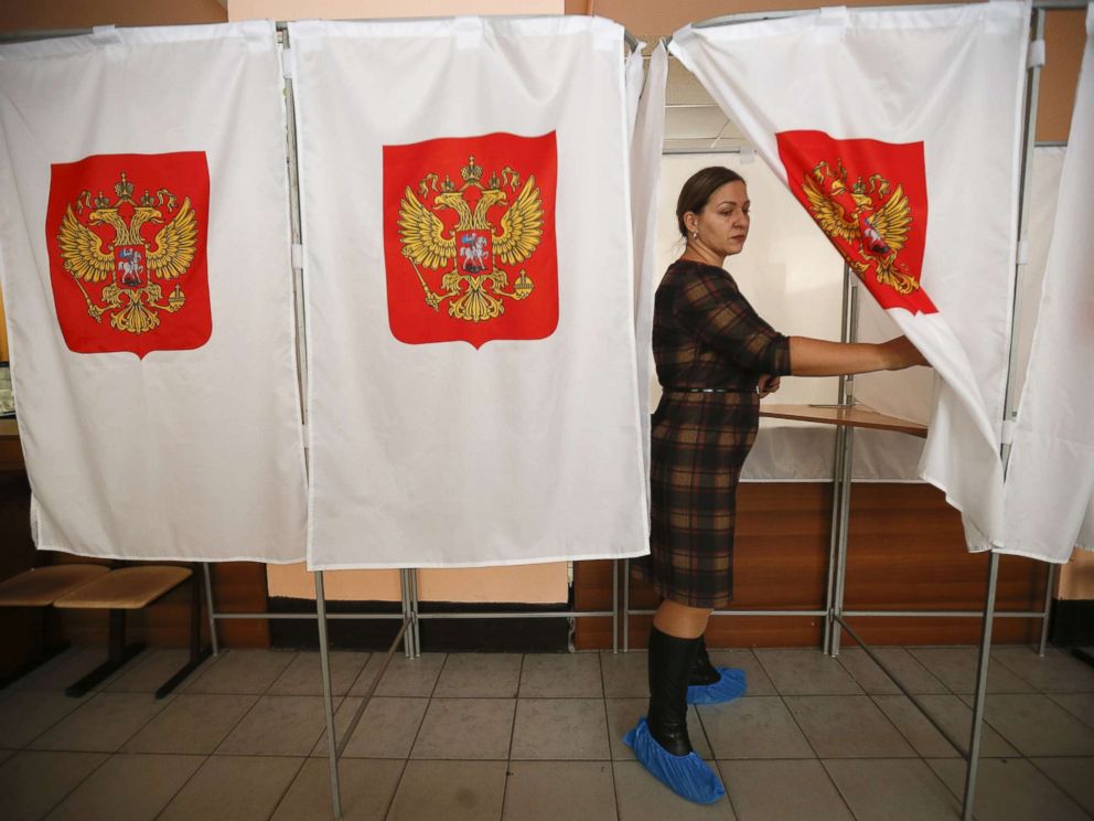 PHOTO: A member of a local electoral commission walks out of a voting booth at a polling station during preparations for the upcoming presidential election in Moscow, March 16, 2018.