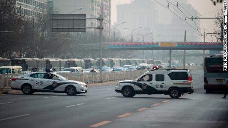 Chinese police cars block a road near the Diaoyutai State Guesthouse in Beijing Tuesday.