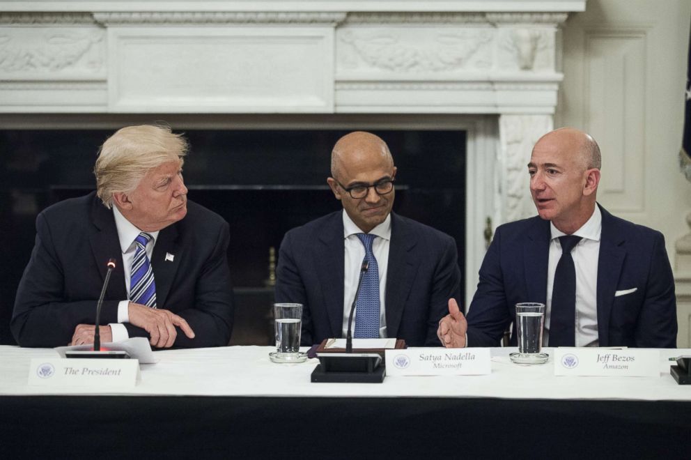 PHOTO: Jeff Bezos, far right, speaks as President Donald Trump, left, and Satya Nadella, chief executive officer of Microsoft Corp., listen during the American Technology Council roundtable hosted at the White House, June 19, 2017. 