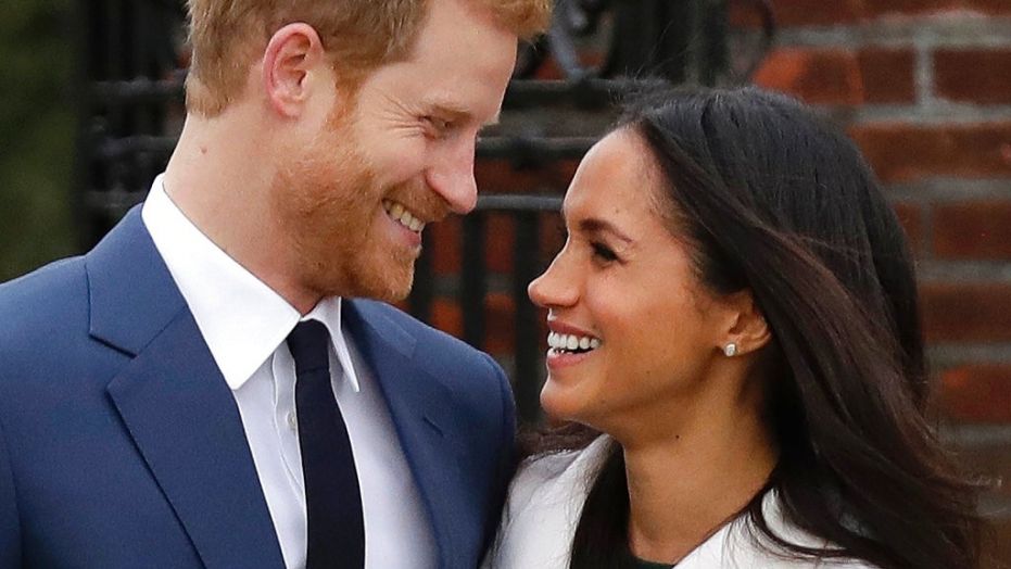 FILE - In this file photo dated  Monday Nov. 27, 2017, Britain's Prince Harry and his fiancee Meghan Markle pose for photographers in the grounds of Kensington Palace in London, following the announcement of their engagement. Prince Harry and his fiancee, American actress Meghan Markle, have released more details about their May 19 wedding, revealing that the event will include a carriage ride through Windsor so they can share the big day with the public. The couple will marry at noon in St Georgeâs Chapel, the 15th-Century church on the grounds of Windsor Castle that has long been the backdrop of choice for royal occasions. Harry's grandmother, Queen Elizabeth II, gave permission for use of the venue and will attend the wedding.  (AP Photo/Matt Dunham, File)