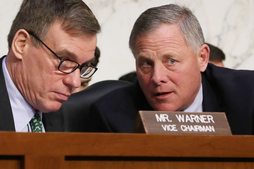 PHOTO: Senate Intelligence Committee ranking member Sen. Mark Warner (L) and Chairman Richard Burr confer during a committee hearing on Capitol Hill on March 21, 2018 in Washington.