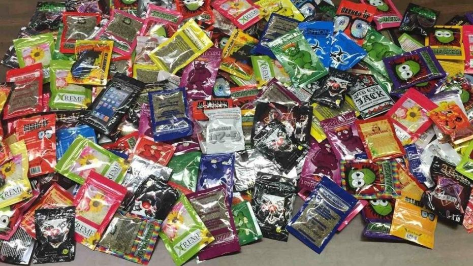 This photo provided Friday, Aug. 7, 2015 by New York Police Department shows packets of synthetic marijuana seized after a search warrant was served at a newsstand in Brooklyn, N.Y. 