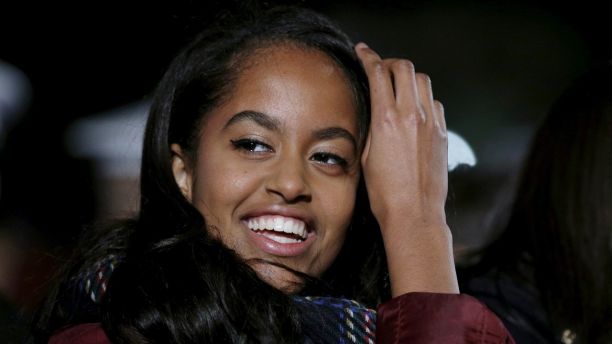 Malia Obama pushes back her hair as she and the Obama family attend the National Christmas Tree Lighting and Pageant of Peace ceremony on the Ellipse Washington December 3, 2015.    REUTERS/Kevin Lamarque  - GF20000084520