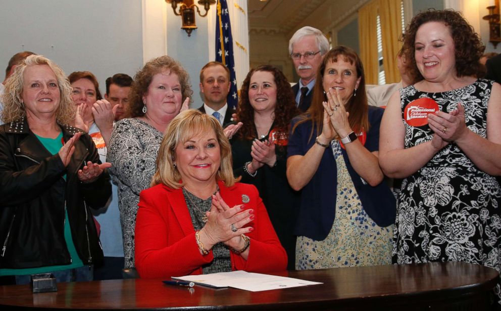 PHOTO: Surrounded by teachers and legislators, Oklahoma Gov. Mary Fallin applauds after signing a teacher pay raise bill in Oklahoma City, March 29, 2018.