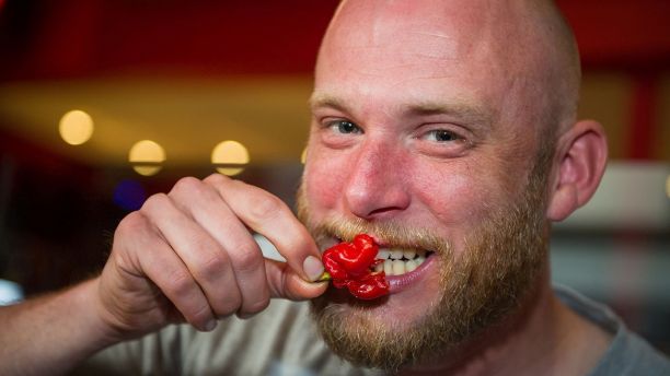EMBARGOED 11.30pm BST Monday (9-APR-2018 18:30 ET/22:30 GMT)File photo of a Rob Radcliffe age 36 with a  'Carolina Reaper' chilli after an unknown man was left with thunderclap headaches from eating the famous pepper. See National News story NNCHILLI; A man bit off more than he could chew when he tackled the world's hottest chilli the 'Carolina Reaper' and was left with excruciating "thunderclap" headaches. In the first ever recorded case of a chilli causing these types of headaches, the man over the next few days experienced short splitting pains lasting seconds at a time. The 34-year-old had eaten  just one of the chillies at a chilli eating contest. Immediately he began dry heaving and then developed intense neck and head pain starting at the back which then spread across the whole of the head.