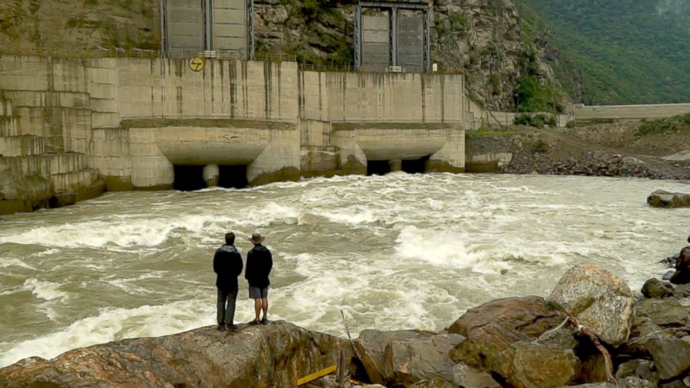 PHOTO: Bob Woodruff and River guide Sonam Toby Tobgay stand in front of the still-under-construction Punatsangchhu-1 Hydropower Project.