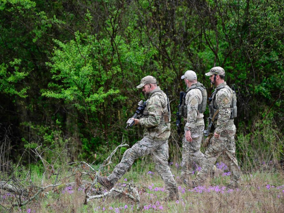 PHOTO: ATF personnel search a wooded area, April 23, 2018 near the Church of Christ Burnette Chapel, scene of the 2017 Antioch church shooting, for the gunman who shot and killed four people April 22, in a nearby Waffle House in Nashville, Tenn. 