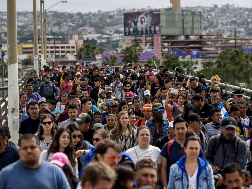 PHOTO: Members of a caravan of Central Americans who spent weeks traveling across Mexico walk from Mexico to the U.S. side of the border with supporters to ask authorities for asylum on April 29, 2018 in Tijuana, Baja California Norte, Mexico.