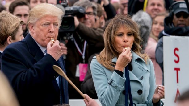 President Donald Trump and first lady Melania Trump blow whistles to start a race at the annual White House Easter Egg Roll on the South Lawn of the White House in Washington, Monday, April 2, 2018. (AP Photo/Andrew Harnik)