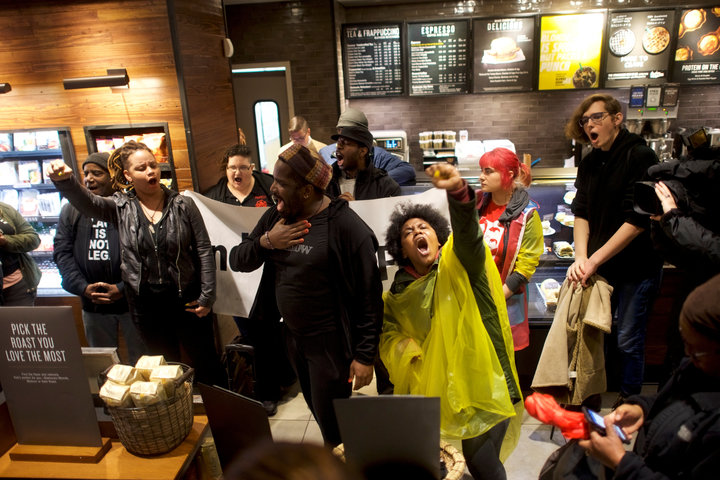 Demonstrators inside a Starbucks in Philadelphia on Monday,&nbsp;protesting after two black men were arrested in the store la