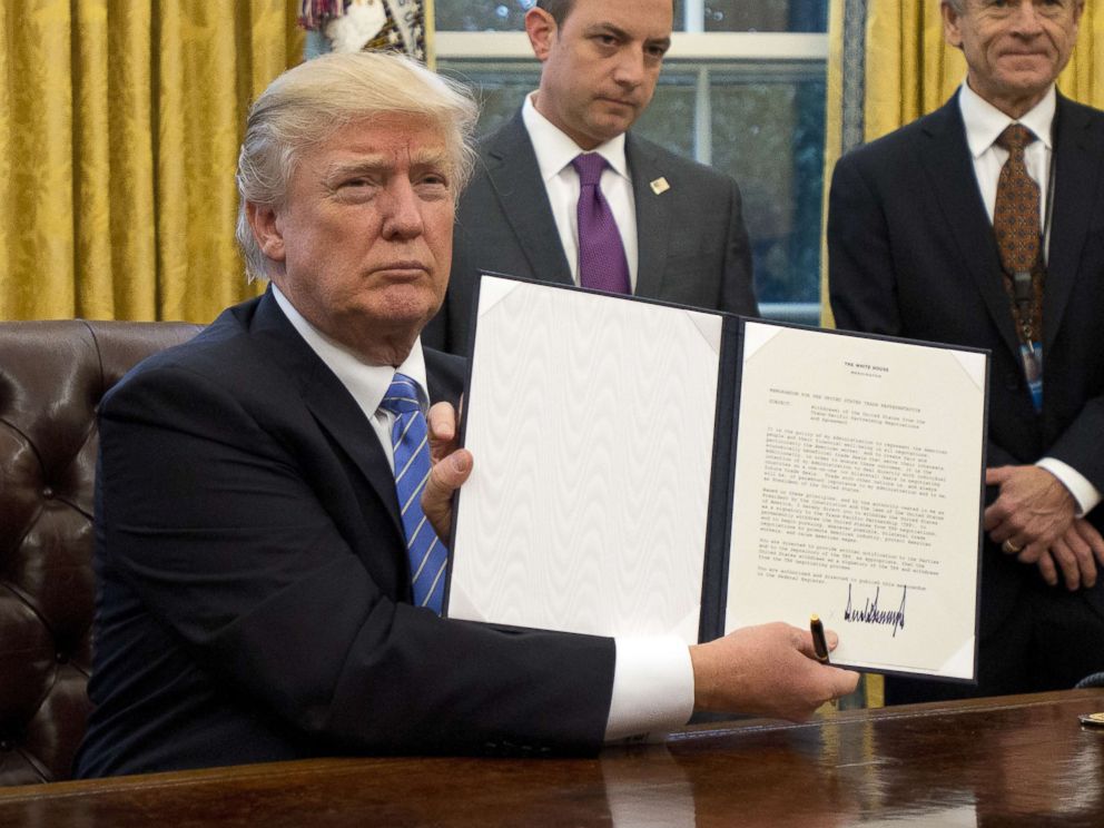 PHOTO: President Donald Trump holds an executive order titled Mexico City Policy, which bans federal funds going to overseas organizations that perform abortions, Jan. 23, 2017.