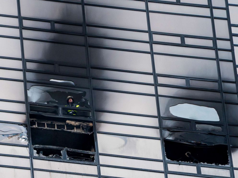 PHOTO: A firefighter looks out from the window of a damaged apartment in Trump Tower in New York, April 7, 2018. The New York Fire Department says the blaze broke out on the 50th floor shortly before 6 p.m. Saturday.