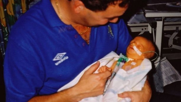 Anti bullying campaigner Ashley Collins who has Treacher Collins syndrome - he is pictured here aged shortly atter birth with dad Michael. See SWNS story SWBULLY; A teenage anti-bullying campaigner with a rare genetic disorder which causes facial deformity was "insulted" after being contacted by Channel 4 show - The Undateables. Brave Ashley Carter, 17, was born with Treacher Collins syndrome and was bullied as a child before becoming an anti-bullying campaigner. He has appeared on shows such as Loose Women, The Jeremy Kyle Show and ITV News West Country to share his story. But he was horrified to receive an email from Channel 4 researcher for The Undateables, described as a âdocumentary series following people with challenging conditions who are looking for love.â
