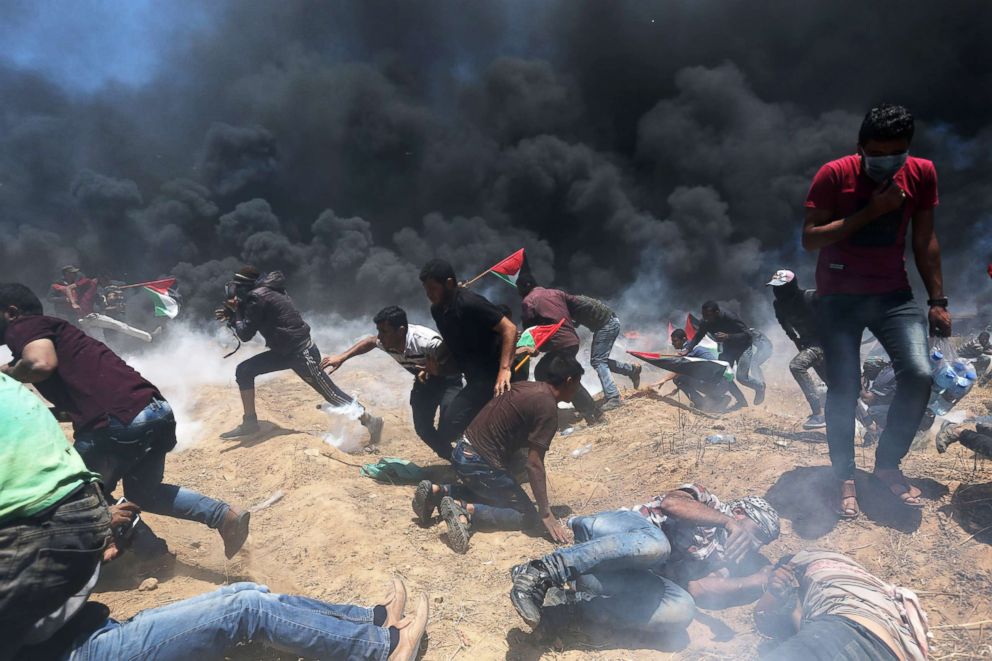 PHOTO: Palestinian demonstrators run for cover from Israeli fire and tear gas during a protest against U.S. embassy move to Jerusalem at the Israel-Gaza border in the southern Gaza Strip May 14, 2018.
