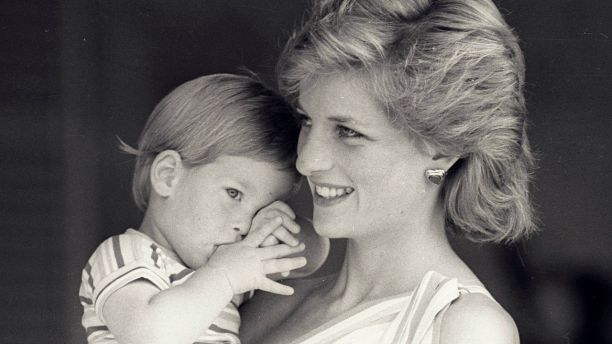 Young Prince Harry tries to hide behind his mother Princess Diana during a morning picture session at Marivent Palace on August 9, 1988, where the Prince and Princess of Wales are holidaying as guests of King Juan Carlos and Queen Sofia.    REUTERS/Hugh Peralta - GF2DUBFABYAF