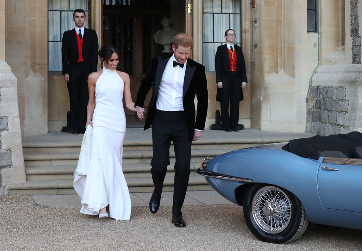 Harry helped his bride into a blue Jag before they set off to a private reception.