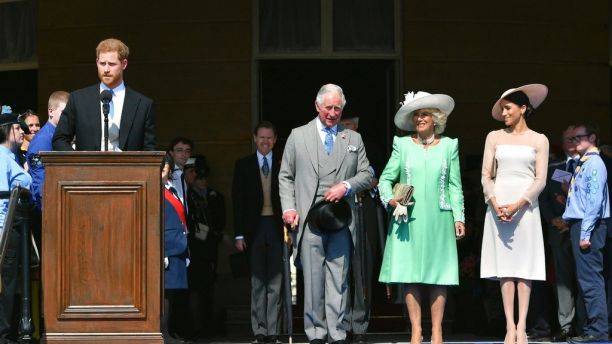 Britain's Prince Harry speaks, as Prince Charles, Camilla, the Duchess of Cornwall and Meghan, the Duchess of Sussex listen, during a garden party at Buckingham Palace in London, Tuesday May 22, 2018. The event is part of the celebrations to mark the 70th birthday of Prince Charles.  (Dominic Lipinski/Pool Photo via AP)