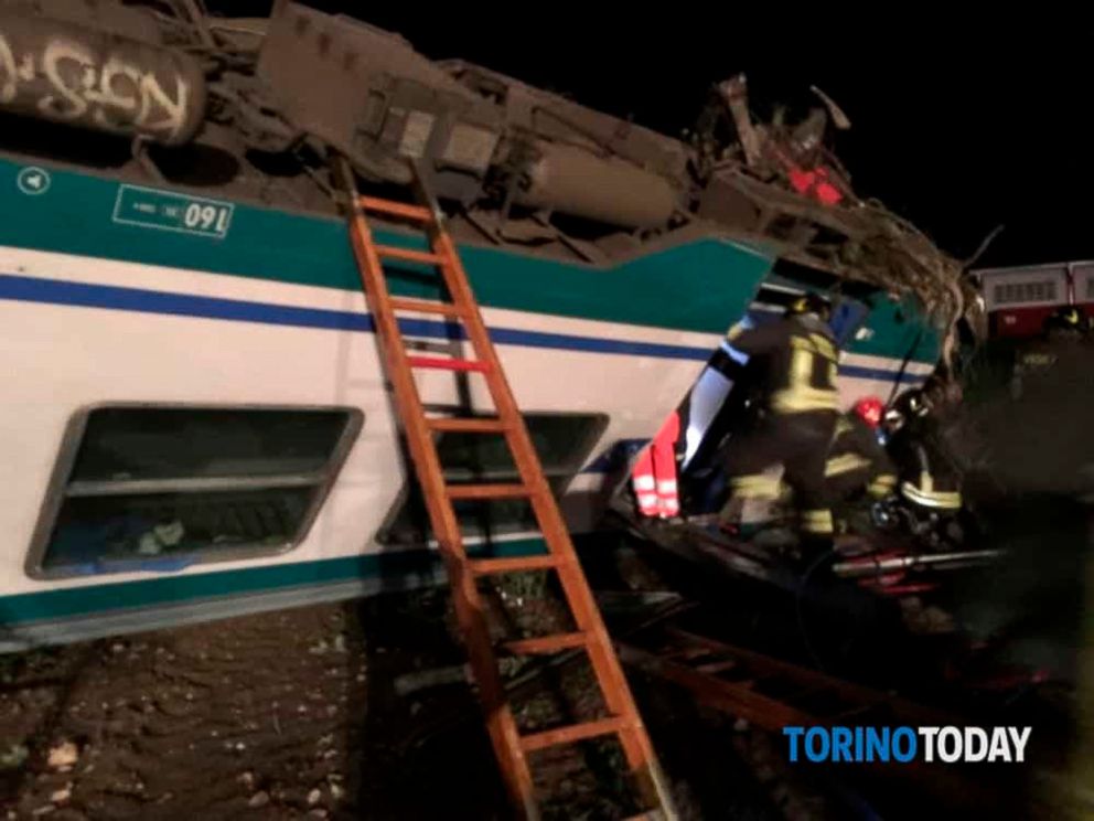Firemen and rescue personnel get to a train that plowed into a big-rig truck that was on the tracks, killing the trains engineer and injuring 16 passengers near Turin, northern Italy, early Thursday, May 24, 2018. The Italian news agency ANSA quoted