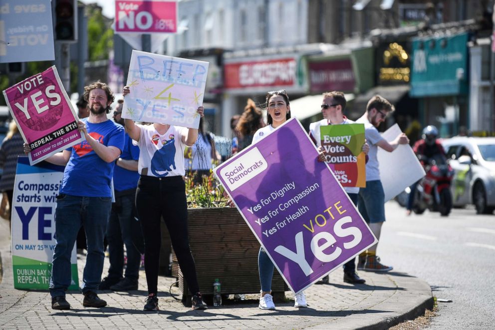 PHOTO: People hold yes placards as the country heads to polling stations, May 25, 2018 in Dublin, Ireland. Voters will decide whether or not to abolish the 8th amendment which makes abortions illegal, except when the mothers life is at risk.