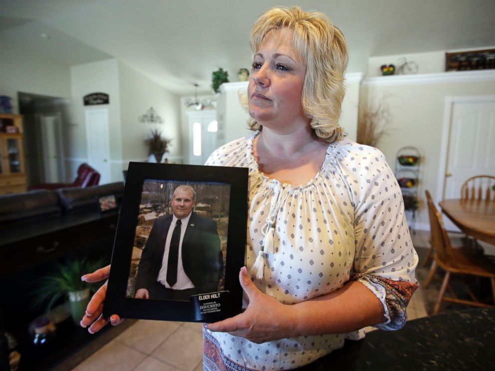 In this July 13, 2016 file photo, Laurie Holt holds a photograph of her son Josh Holt at her home, in Riverton, Utah.