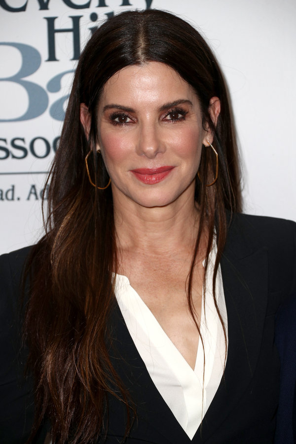 Sandra Bullock's signature&nbsp;hairstyle -- long chocolate-brown locks with just a hint of caramel color toward the ends --&