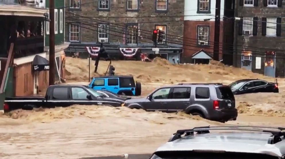 PHOTO: Water rushes through Main Street in Ellicott City, Md., May 27, 2018. 