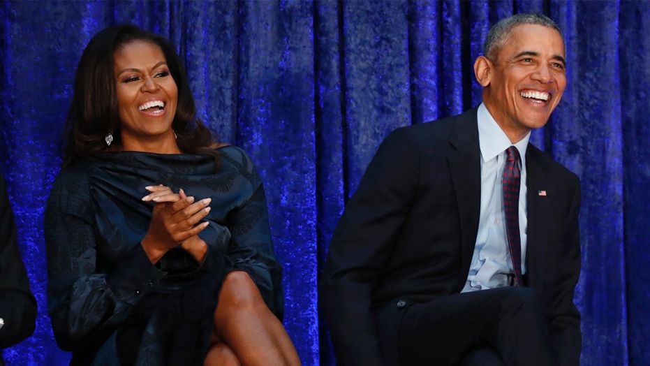 Former U.S. President Barack Obama sits with former first lady Michelle Obama prior during the unveiling of their portraits at the Smithsonian’s National Portrait Gallery in Washington, U.S., February 12, 2018.
