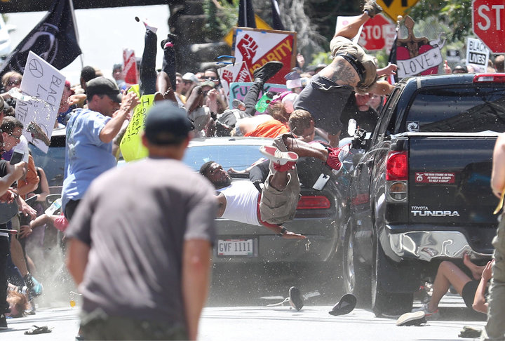 Marcus Martin, seen in a white shirt, pushed his fiancee out of the way before a car targeting anti-racist protestors hit him