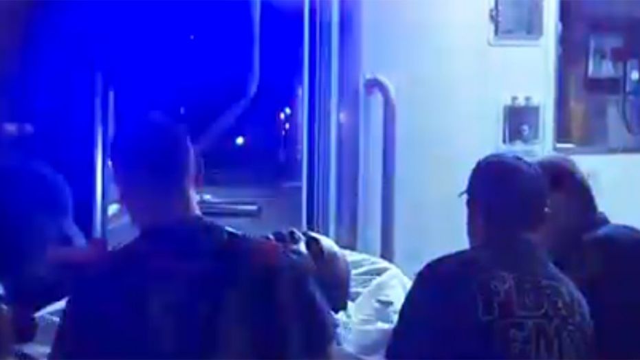 An unidentified patient is loaded into an ambulance on Saturday after police responded to reports of a mass overdose in Brooklyn.