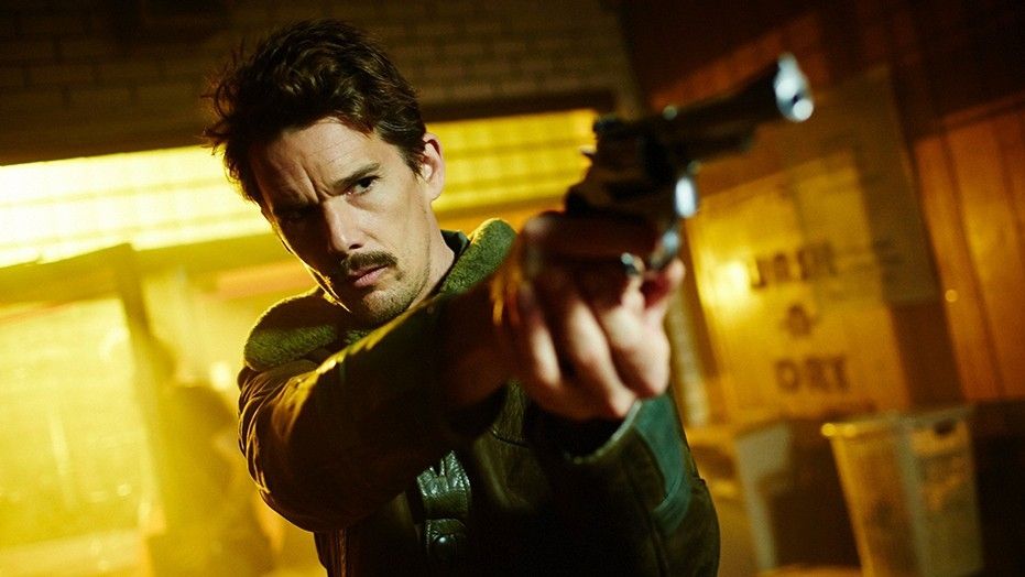 Ethan Hawke said he gets paid more in movies where there are guns. He's pictured here in the 2015 film "Predestination."
