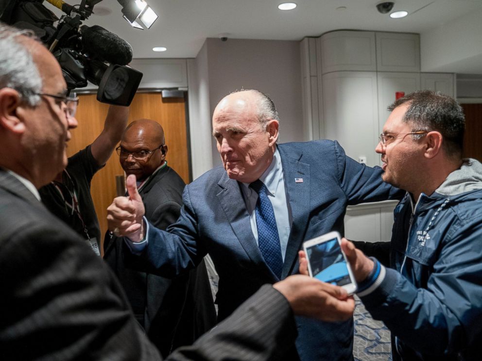 Rudy Giuliani, center, an attorney for U.S. President Donald Trump, leaves after speaking at the Iran Freedom Convention for Human Rights and democracy at the Grand Hyatt, Saturday, May 5, 2018, in Washington.