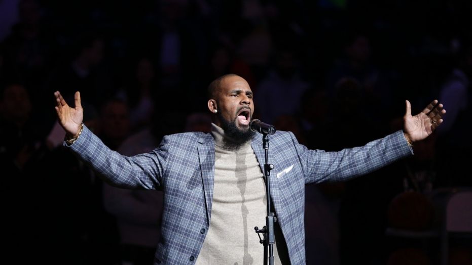 FILE - In this Nov. 17, 2015 file photo,  R. Kelly performs the national anthem before an NBA basketball game between the Brooklyn Nets and the Atlanta Hawks in New York. Court documents show the R&B singer  has been evicted from two Atlanta-area homes over unpaid rent.  The Feb. 13, 2018 filings with the Fulton County magistrate court show Kelly owes more than $31,000 in past due payments to SB Property Management Global.  (AP Photo/Frank Franklin II, File)