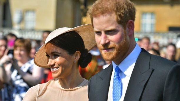 Meghan, the Duchess of Sussex walks with her husband, Prince Harry as they attend a garden party at Buckingham Palace in London, Tuesday May 22, 2018. The event is part of the celebrations to mark the 70th birthday of Prince Charles.  (Dominic Lipinski/Pool Photo via AP)