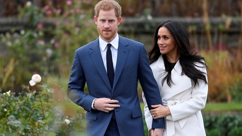 Britain's Prince Harry poses with Meghan Markle in the Sunken Garden of Kensington Palace, London, Britain, November 27, 2017.