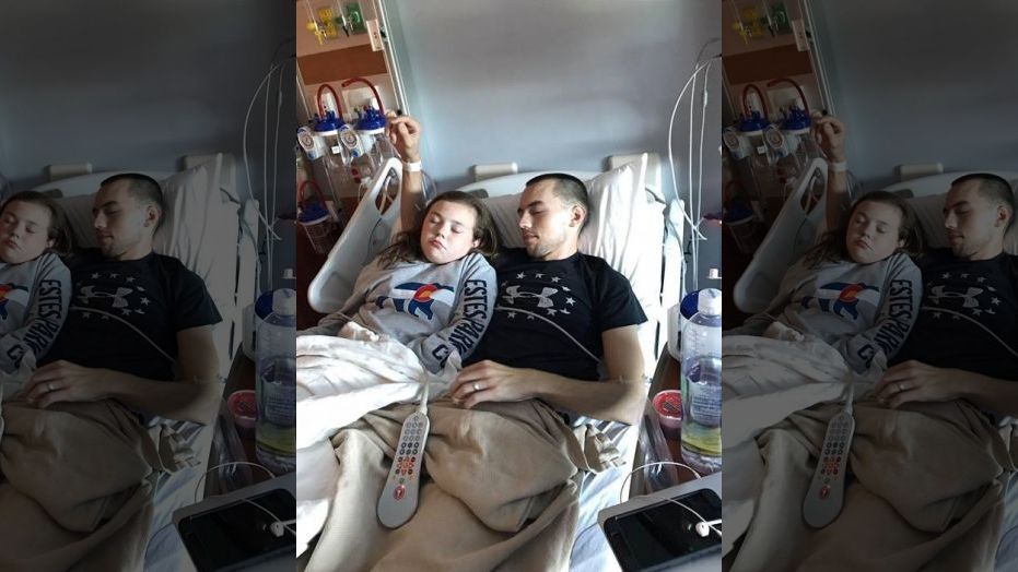 Grace rests next to her father, Jeff, as he recovers in the hospital. 