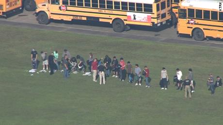 Students empty their backpacks outside Santa Fe High School Friday.
