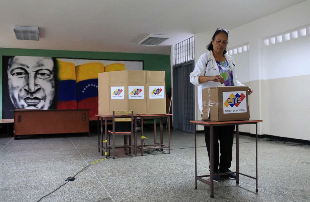 PHOTO: With an image of the late Venezuelan President Hugo Chavez behind her, a Venezuelan citizen casts her vote at a polling station during the presidential election in Caracas, Venezuela, May 20, 2018.