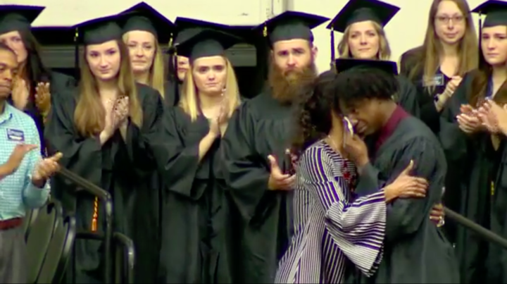 Di'Angelo Groves is embraced by his mother, Shirl Baker, before accepting his own diploma on Saturday.