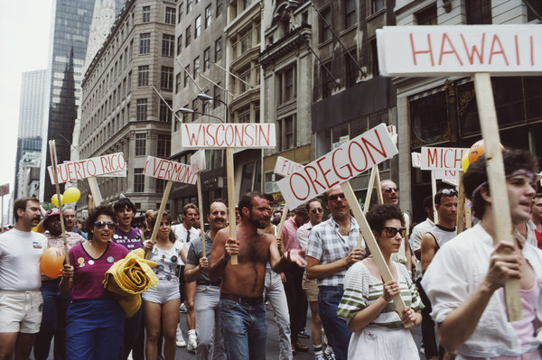 Men and women carry signs during the gay Pride parade in New York City, June 1984.