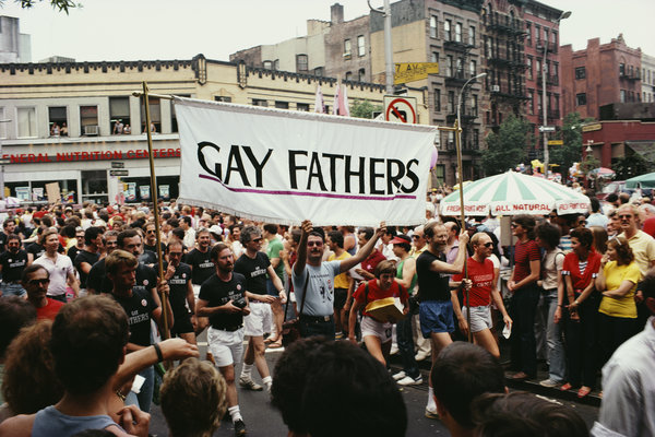 Gay Fathers take part in a gay Pride parade on the corner of Christopher Street and Seventh Avenue S in New York City, June 1
